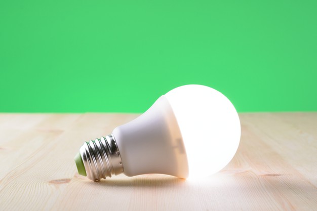 led-lamp-lying-wooden-table_168730-1201